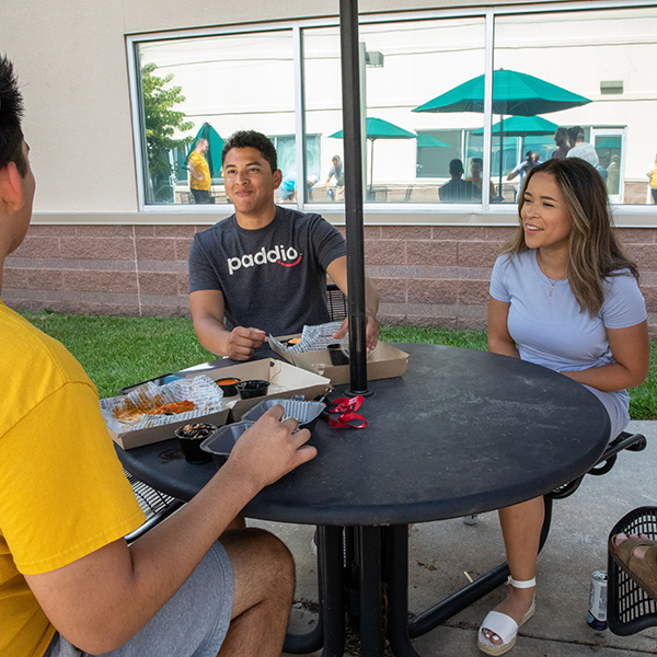 paddio employees eating outside at a table